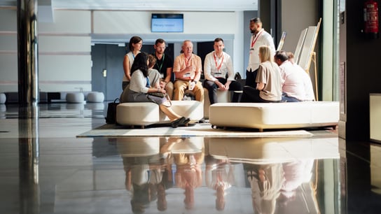 A group of employees seated and discussing togheter