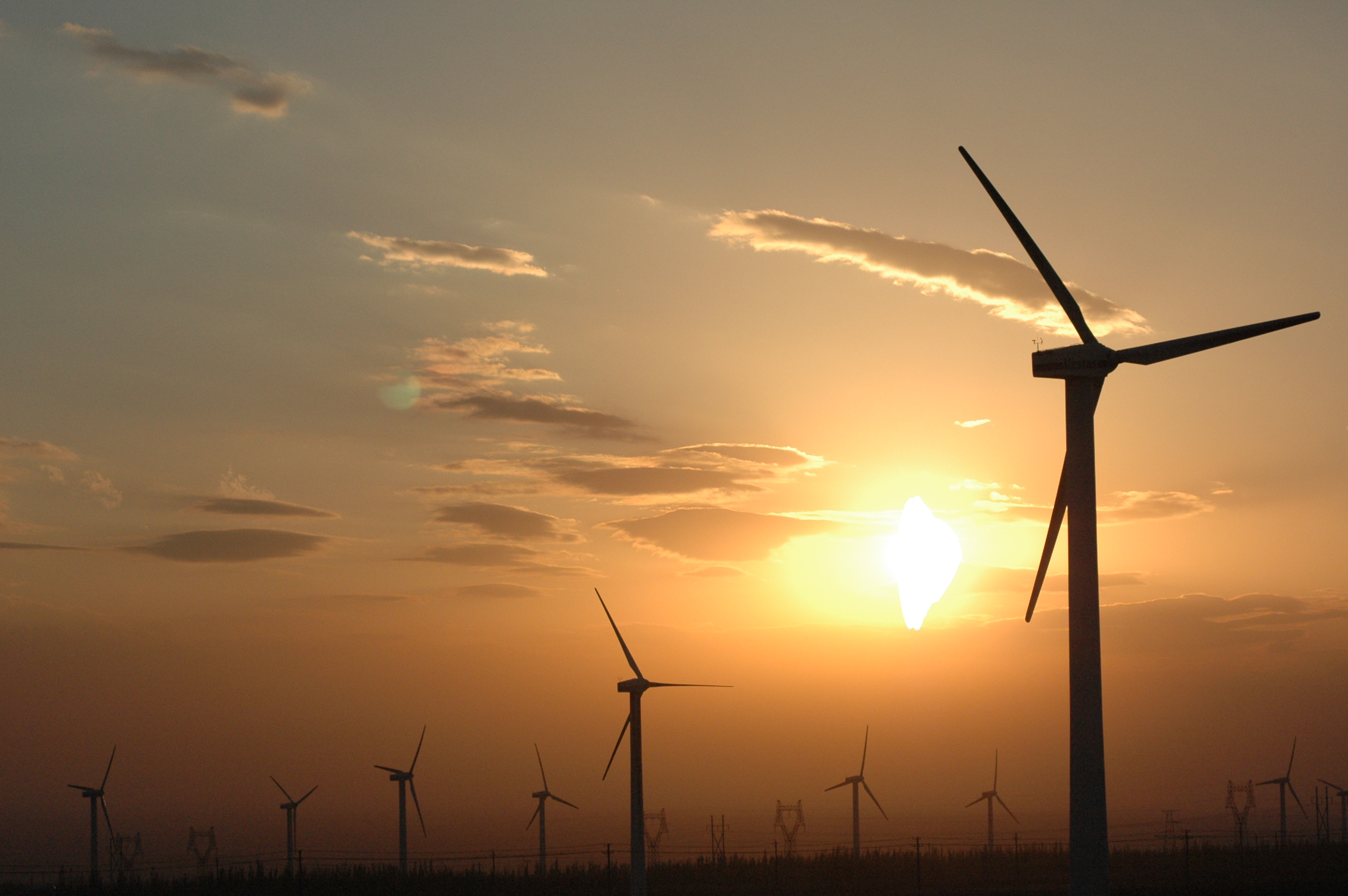 Energy - Wind turbine technicians walking at the site work inspecting the area