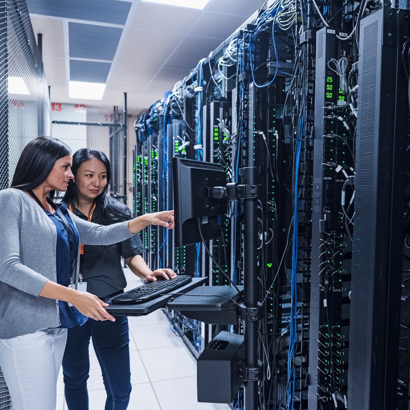 Two women are having a discussion in the machine room.