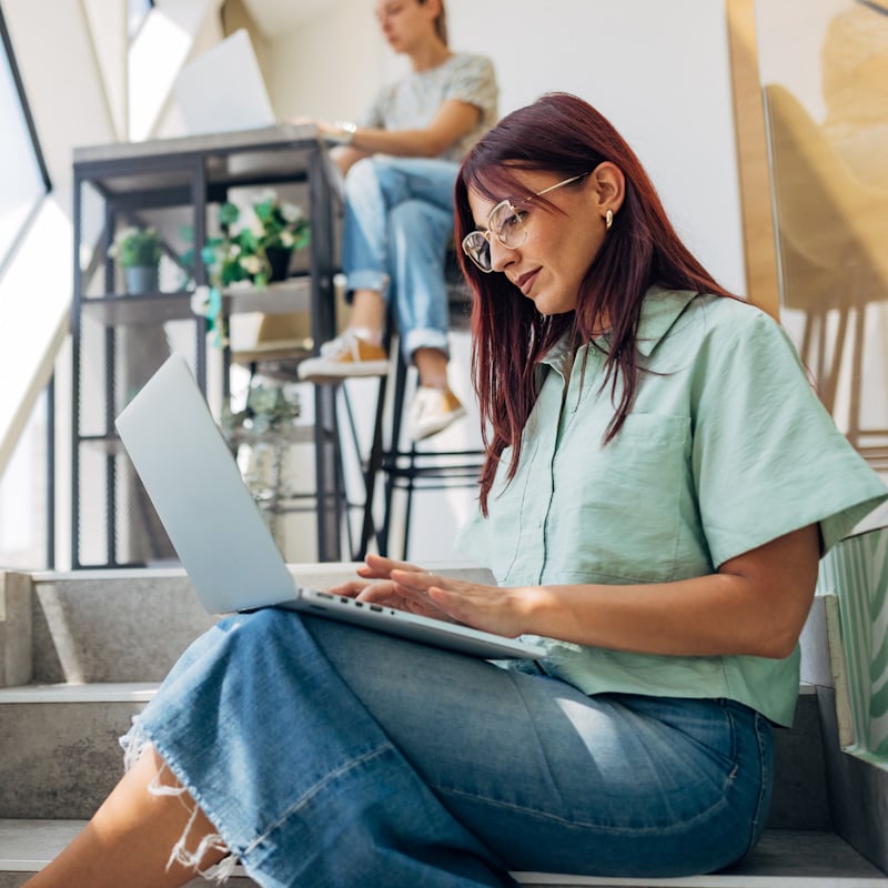 Happy female using laptop working