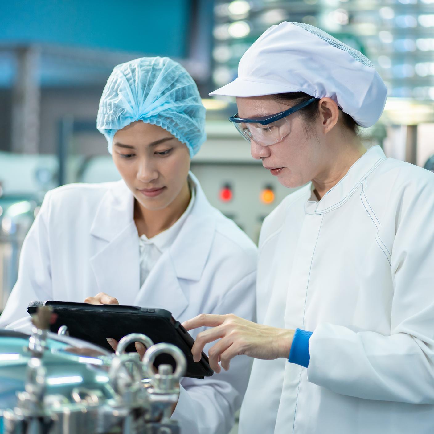 Two lab technicians discussing data