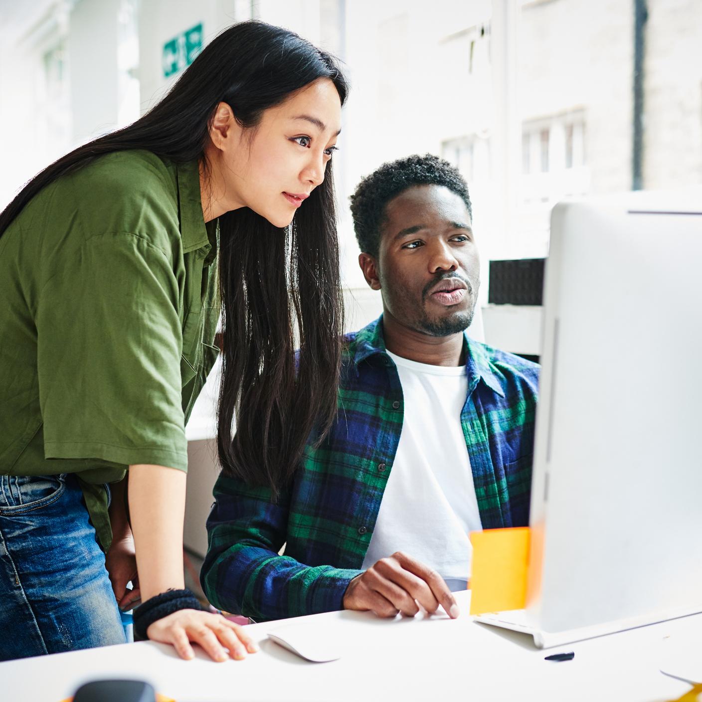 two people looking at laptop 