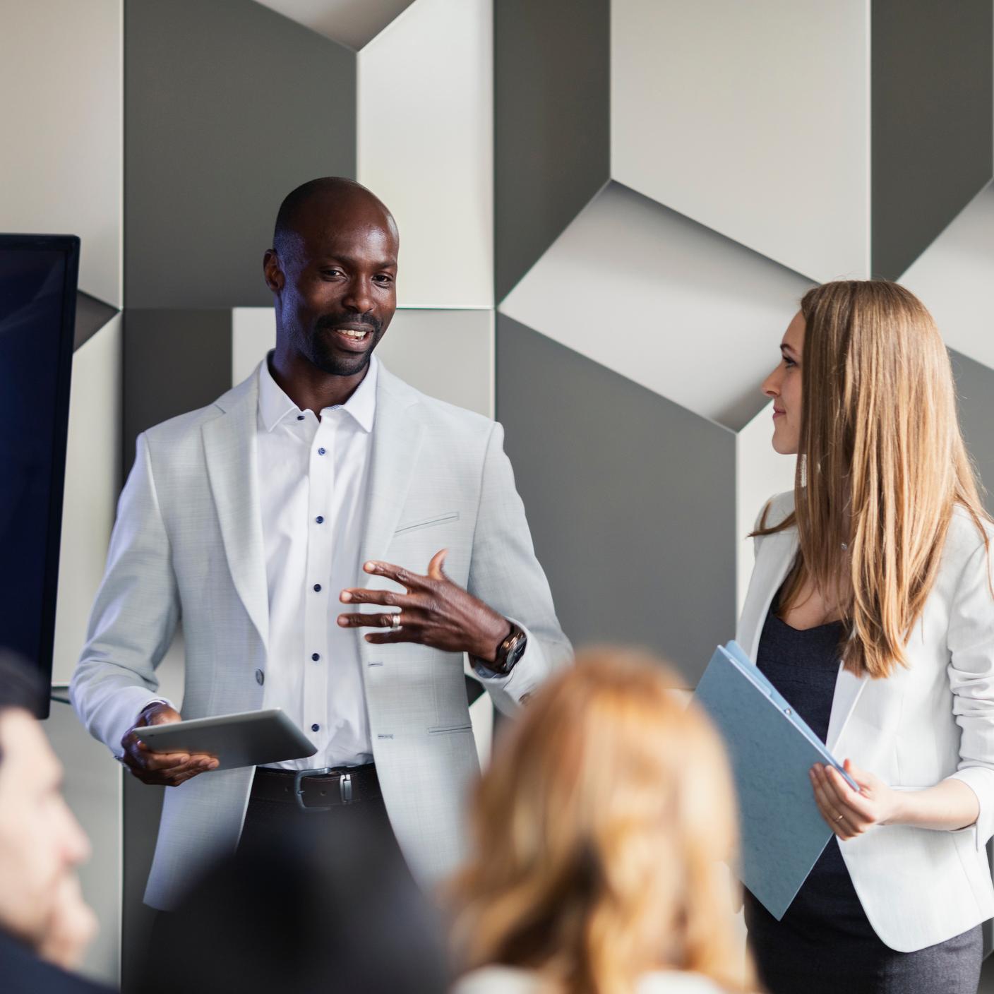 Multiple people in an office meeting.