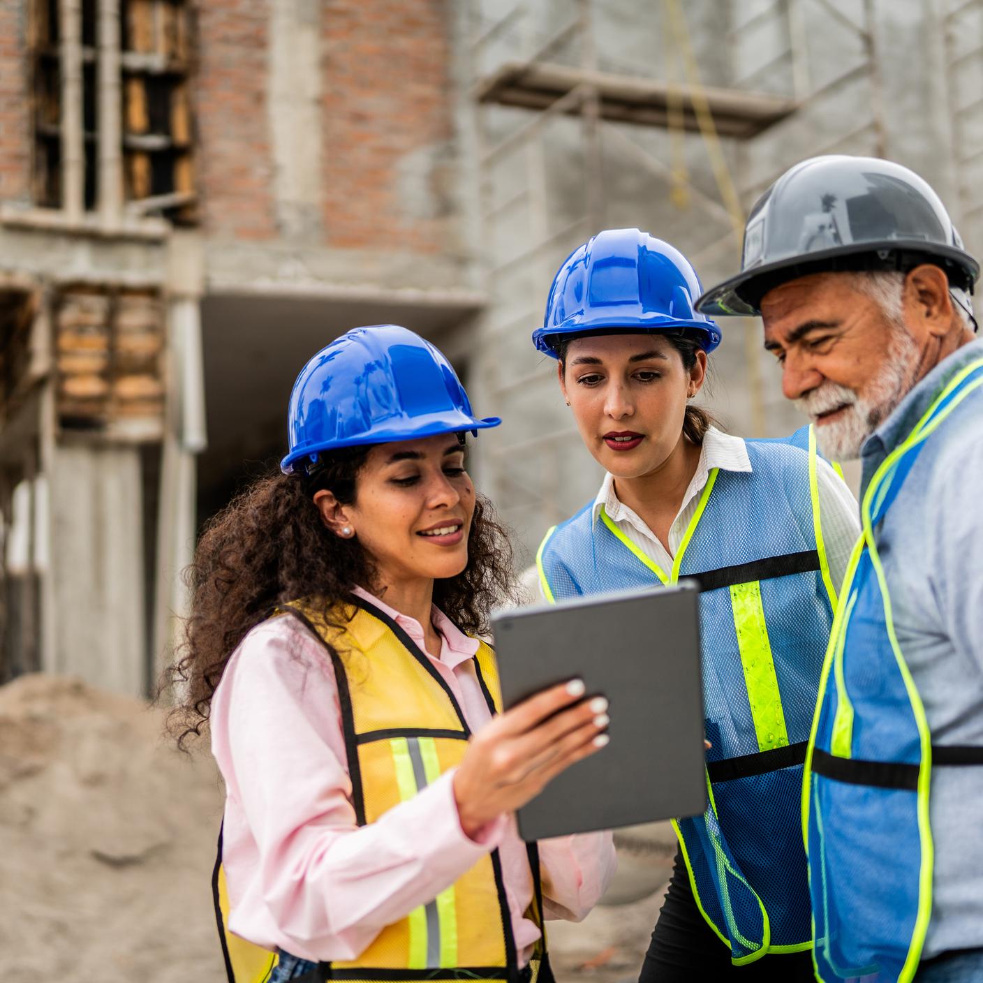 People looking at notes at construction site 