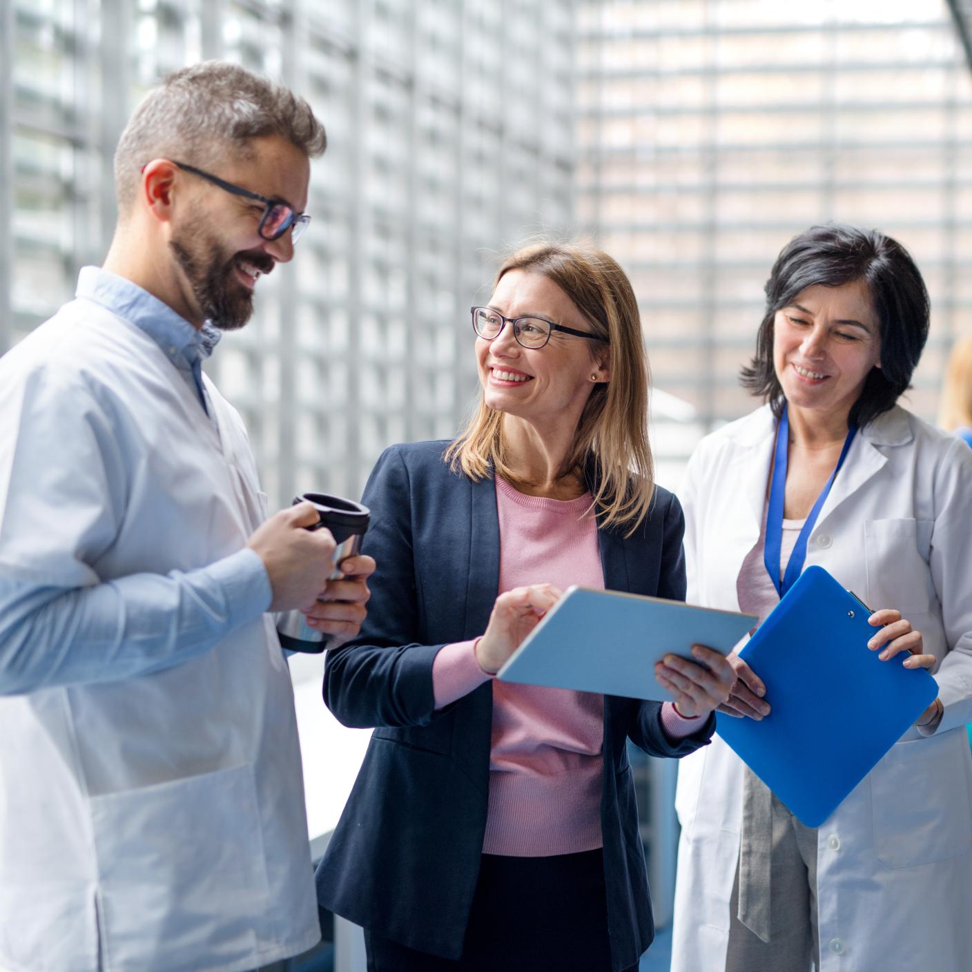Group of doctors talking to pharmaceutical sales representative on conference.