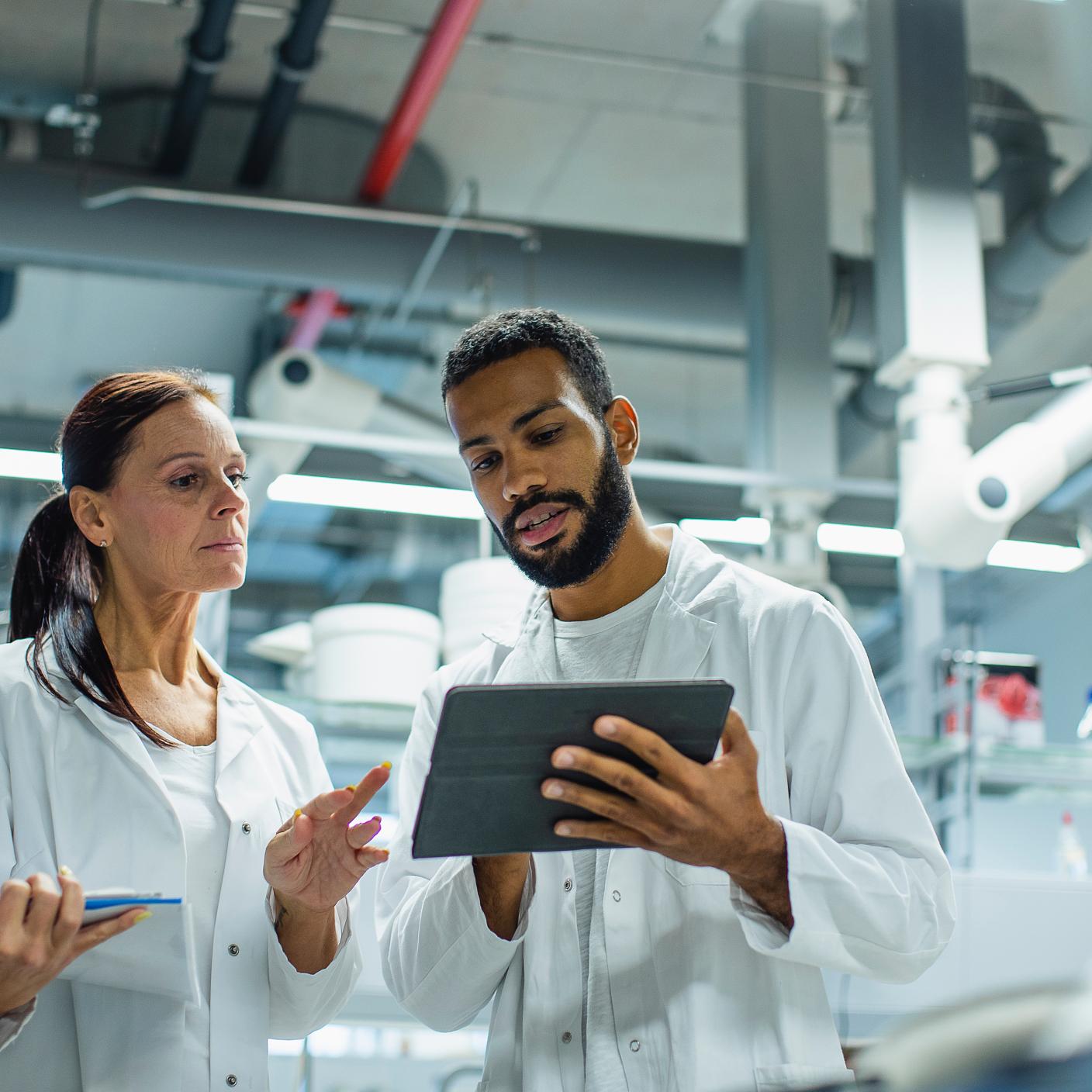 Two doctors looking at tablet