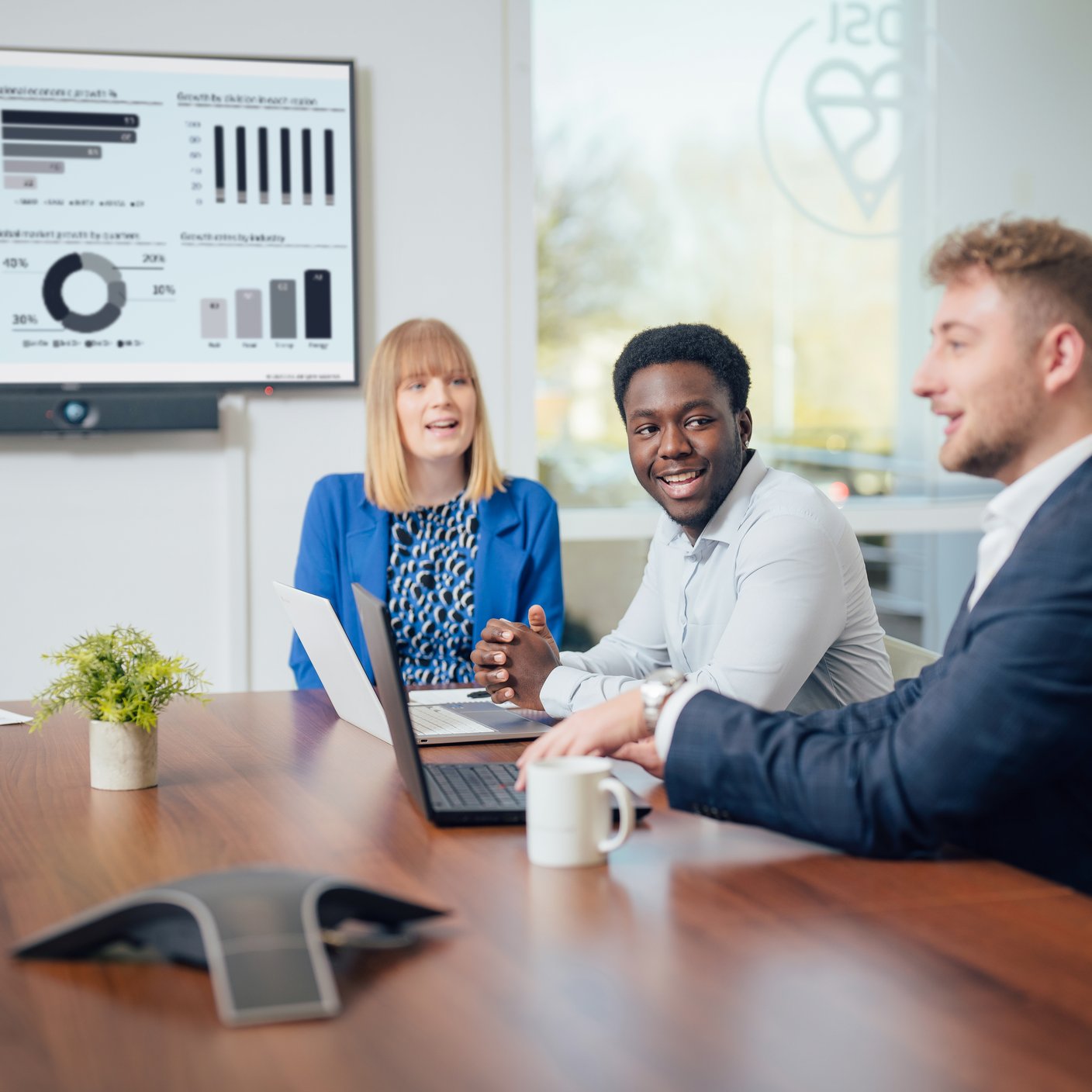 Three employees discussing in a meeting