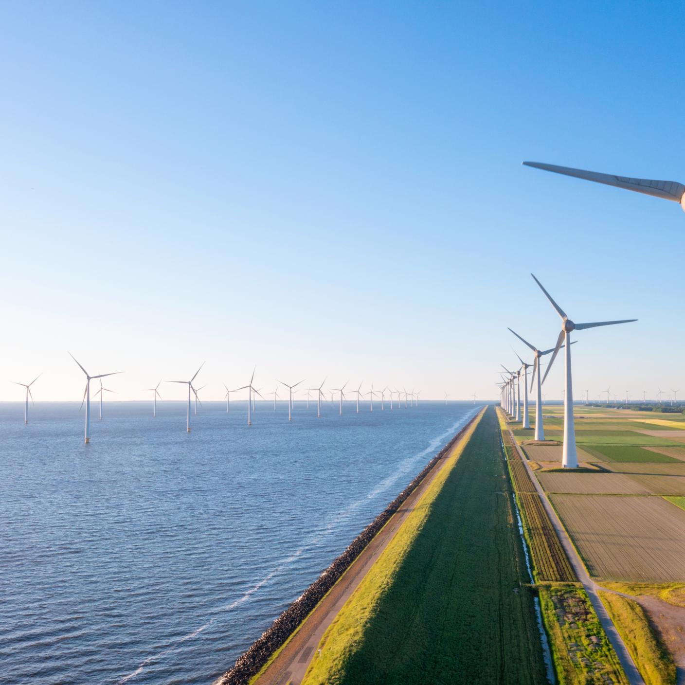 Onshore and offshore wind turbines in a row This is a drone photo of the offshore wind farm in the Flevoland province of the Netherlands, near Urk.