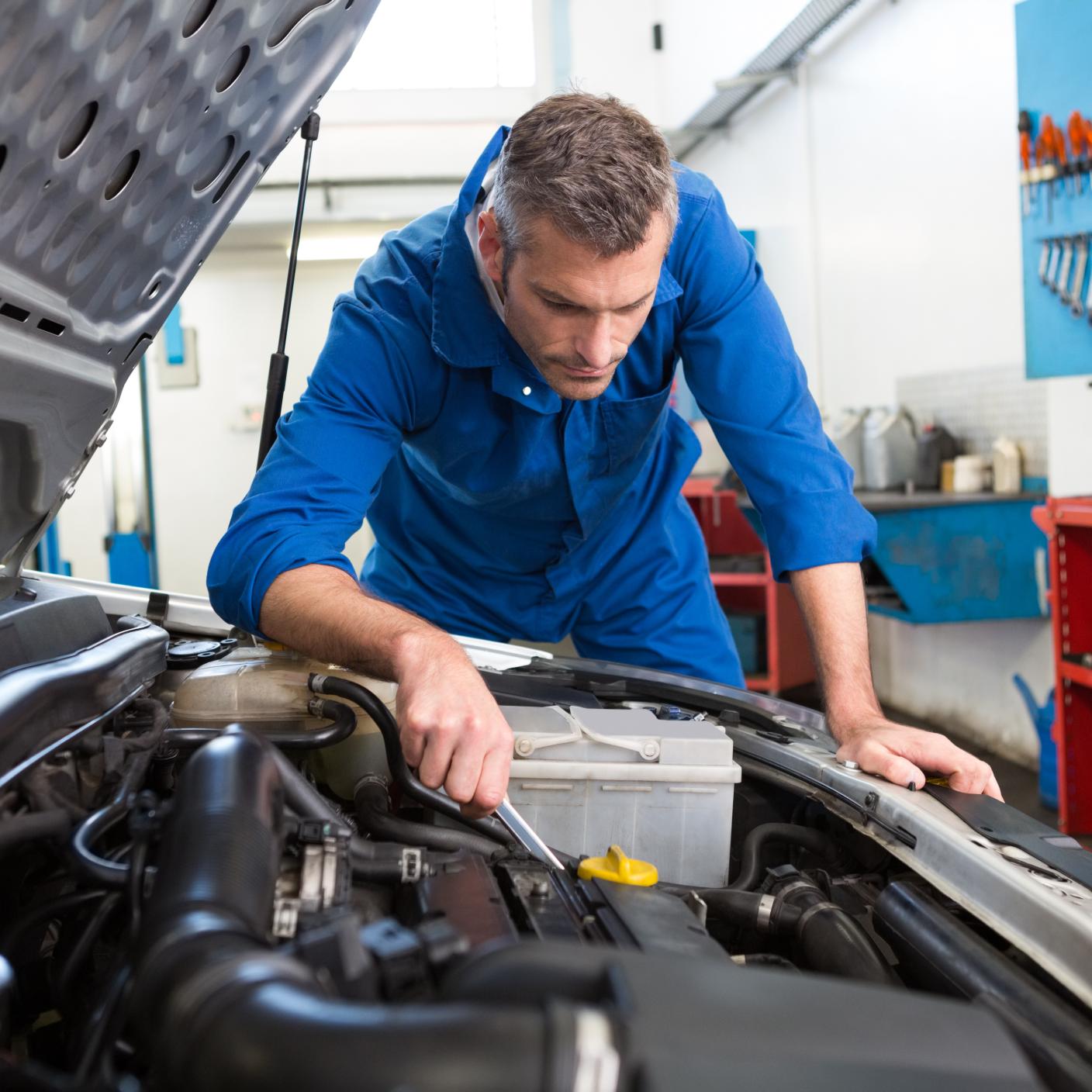 Man working on car engine 