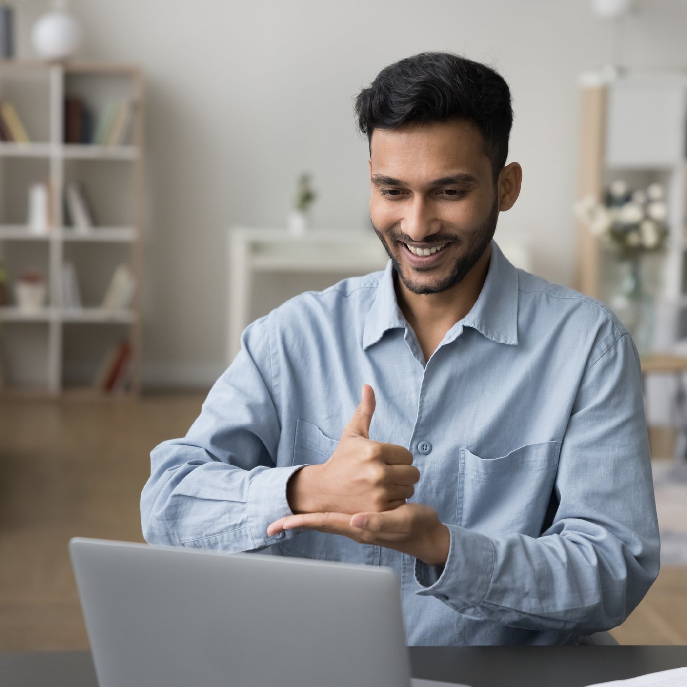 Positive sign language therapist speaking with gestures on video call.