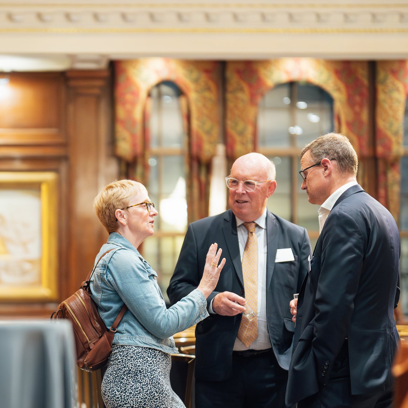 Multiple people speaking at an event.