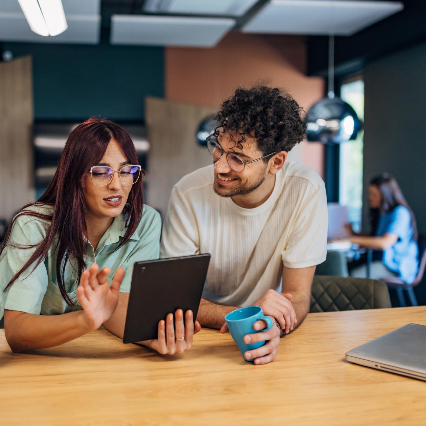 man and women looking at tablet 