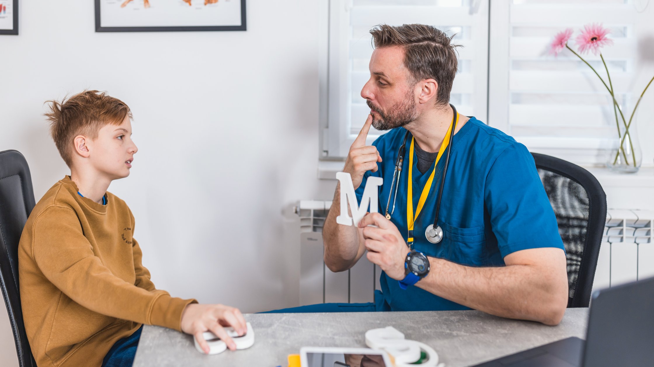 At the speech therapist's office, a boy works on building his voice and confidence, navigating through exercises designed to enhance his verbal expression.