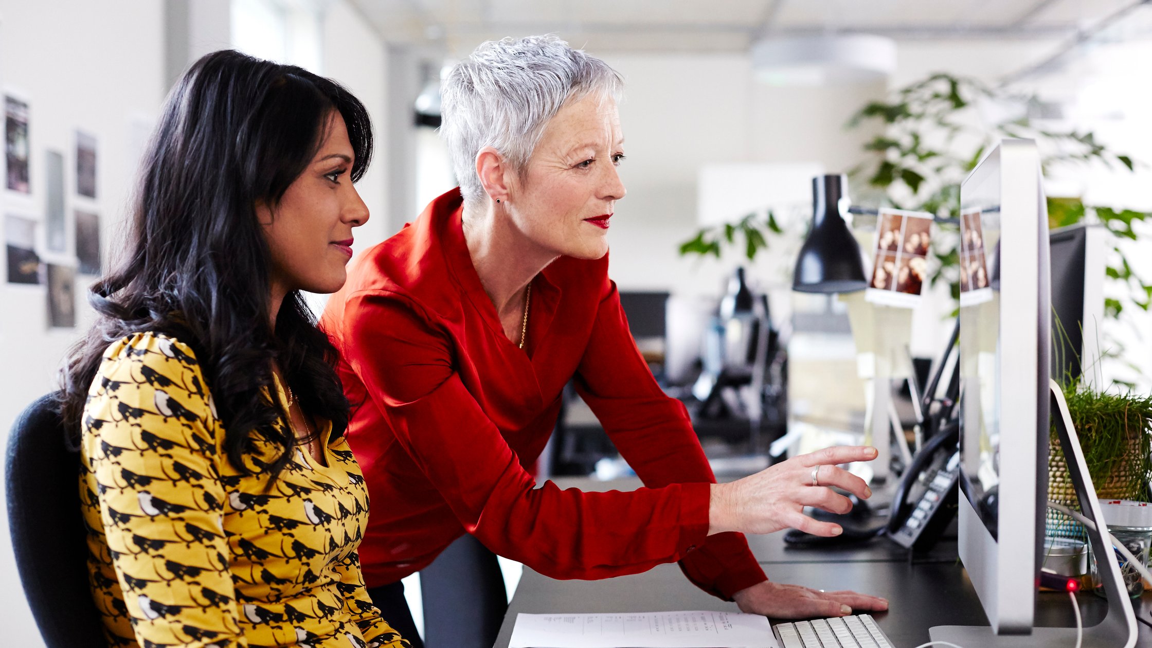 Mature business woman mentoring younger employee