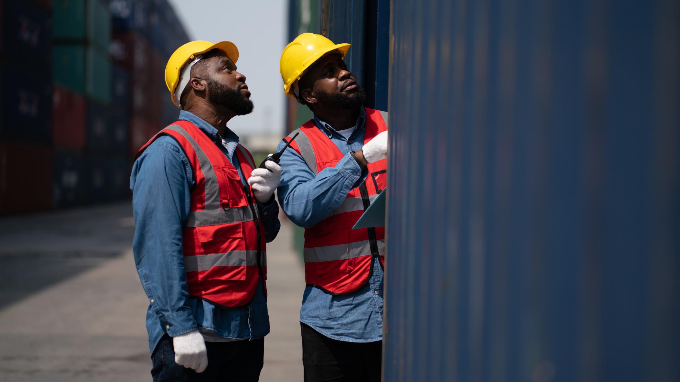 Adults work professionally transporting goods.man business engineer in container transportation industry.Shipping Container Distribution Warehouse Technology.